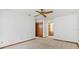 Bedroom features neutral carpet, a ceiling fan, closet, and en-suite bathroom at 8988 Angelica Dr, Orlando, FL 32836
