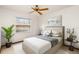 Bedroom featuring a ceiling fan, window, plants, and artwork at 8988 Angelica Dr, Orlando, FL 32836