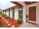Inviting entryway with a decorated front door and stepping stones surrounded by green shrubs at 8988 Angelica Dr, Orlando, FL 32836