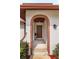Welcoming front entrance with brick archway, elegant front door, and decorative wreath at 8988 Angelica Dr, Orlando, FL 32836
