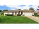 Charming single-story home boasts a manicured lawn and mature landscaping, enhancing its curb appeal at 8988 Angelica Dr, Orlando, FL 32836