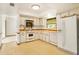 Classic kitchen with white appliances, cabinets, and tile floors, complemented by natural light at 8988 Angelica Dr, Orlando, FL 32836