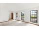 Spacious, sunlit living room with large windows, neutral carpet and trim, and a welcoming entrance at 8988 Angelica Dr, Orlando, FL 32836