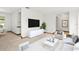 Bright living room with modern design, a mounted flat screen television, and neutral decor at 8988 Angelica Dr, Orlando, FL 32836