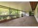 Screened patio with carpeting, overlooking the well-maintained backyard and landscaping at 8988 Angelica Dr, Orlando, FL 32836