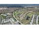 Stunning aerial view of a planned residential community with golf course and resort-style pool at 9014 Stinger Dr, Davenport, FL 33896