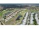 Aerial view of a community with rows of homes, golf courses, and scenic ponds at 9014 Stinger Dr, Davenport, FL 33896