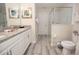 Well-lit bathroom showcases a double vanity, granite countertops, and modern shower at 9014 Stinger Dr, Davenport, FL 33896