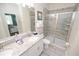 Bathroom featuring granite countertops, a double sink vanity, and a large glass shower at 9014 Stinger Dr, Davenport, FL 33896
