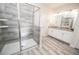 Bathroom featuring a glass shower and a double sink vanity with granite countertops at 9014 Stinger Dr, Davenport, FL 33896