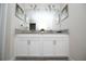 Bathroom showcasing a double sink vanity, large mirror, and modern fixtures at 9014 Stinger Dr, Davenport, FL 33896