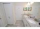 Bathroom featuring dual vanities with granite countertops and white cabinets at 9014 Stinger Dr, Davenport, FL 33896
