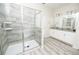Bright bathroom showcasing a tiled shower, stylish fixtures, and a spacious vanity at 9014 Stinger Dr, Davenport, FL 33896
