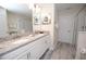 Bright bathroom boasts a double vanity, granite countertops, and a sleek glass shower at 9014 Stinger Dr, Davenport, FL 33896