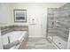 Beautiful bathroom featuring a soaking tub and glass enclosed shower with decorative tile accents at 9014 Stinger Dr, Davenport, FL 33896
