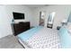 Cozy bedroom featuring a comfortable bed with patterned linens and a dresser with a TV at 9014 Stinger Dr, Davenport, FL 33896