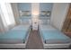 Charming bedroom with twin beds, stylish decor, and a window for natural light at 9014 Stinger Dr, Davenport, FL 33896