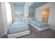 Inviting bedroom features twin beds, stylish decor, and an ensuite bathroom entrance at 9014 Stinger Dr, Davenport, FL 33896