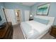 Bright bedroom with blue accent wall, white furniture, and attached bathroom access at 9014 Stinger Dr, Davenport, FL 33896
