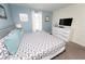 Comfortable bedroom features a dresser with TV and modern decor, creating a relaxing retreat at 9014 Stinger Dr, Davenport, FL 33896