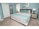Comfortable bedroom featuring stylish decor, a cozy bed, and soothing blue walls at 9014 Stinger Dr, Davenport, FL 33896