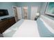 Comfortable bedroom featuring soft carpet, a queen-size bed, dresser, and an adjoining bathroom at 9014 Stinger Dr, Davenport, FL 33896