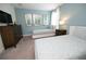 Charming bedroom featuring two twin beds, side table, dresser, and contemporary artwork at 9014 Stinger Dr, Davenport, FL 33896