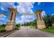 The Champions Gate community entrance with a prominent sign and landscaped surroundings at 9014 Stinger Dr, Davenport, FL 33896