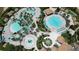 Aerial view of a resort-style community pool area with palm trees and cabanas at 9014 Stinger Dr, Davenport, FL 33896