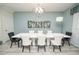 Elegant dining room with modern lighting, white table, and stylish chairs at 9014 Stinger Dr, Davenport, FL 33896