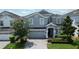 Charming two-story home with a well-manicured lawn and beautiful landscaping at 9014 Stinger Dr, Davenport, FL 33896