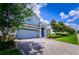 Beautiful two-story home featuring a stone-accented facade and brick driveway at 9014 Stinger Dr, Davenport, FL 33896