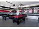 Game room with a pool table, air hockey and colorful sports posters and decor at 9014 Stinger Dr, Davenport, FL 33896