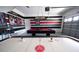 Large game room with air hockey table and pool table, plus sports themed wall decorations at 9014 Stinger Dr, Davenport, FL 33896