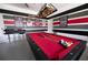 Spacious game room featuring a red pool table under a unique billiard light fixture at 9014 Stinger Dr, Davenport, FL 33896