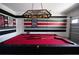 Game room features a red pool table beneath a billiard light fixture at 9014 Stinger Dr, Davenport, FL 33896