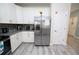 Kitchen showcasing stainless steel refrigerator and white cabinets at 9014 Stinger Dr, Davenport, FL 33896