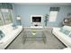 Open concept living room with two white sofas and glass table at 9014 Stinger Dr, Davenport, FL 33896