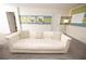 Comfortable living room featuring a white couch with decorative pillows and modern wall decor at 9014 Stinger Dr, Davenport, FL 33896