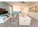Bright living room area featuring modern white couch, TV, and decorative glass coffee table at 9014 Stinger Dr, Davenport, FL 33896