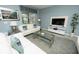 Cozy living room with white sofas, a glass table, and a modern TV console at 9014 Stinger Dr, Davenport, FL 33896
