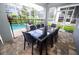 Outdoor dining area with a large table and chairs overlooking the screened-in pool and garden at 9014 Stinger Dr, Davenport, FL 33896