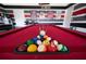 Close-up of red felt pool table with racked balls, ready for an exciting game at 9014 Stinger Dr, Davenport, FL 33896