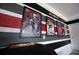 Game room wall features horizontal stripes and framed sports-themed wall art at 9014 Stinger Dr, Davenport, FL 33896
