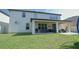Backyard shows a spacious patio area for outdoor dining and entertaining, surrounded by lush green lawn at 9257 Outlook Rock Trl, Windermere, FL 34786