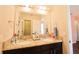 Bathroom features a dual sink vanity, tile floors, and a large mirror at 9257 Outlook Rock Trl, Windermere, FL 34786