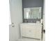 Bathroom features a new vanity with an illuminated mirror, contrasted by a gray accent wall and marble flooring at 9257 Outlook Rock Trl, Windermere, FL 34786