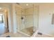 Tiled shower with glass door and bench seating at 9257 Outlook Rock Trl, Windermere, FL 34786
