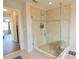 Tiled shower with glass door and built-in shelves at 9257 Outlook Rock Trl, Windermere, FL 34786