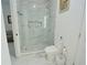 This bathroom displays a glass enclosed shower with marble tiling, complemented by modern fixtures and a sleek toilet at 9257 Outlook Rock Trl, Windermere, FL 34786